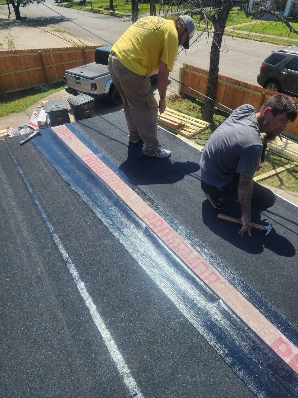 Ad Lib roofer on the job in a yellow shirt