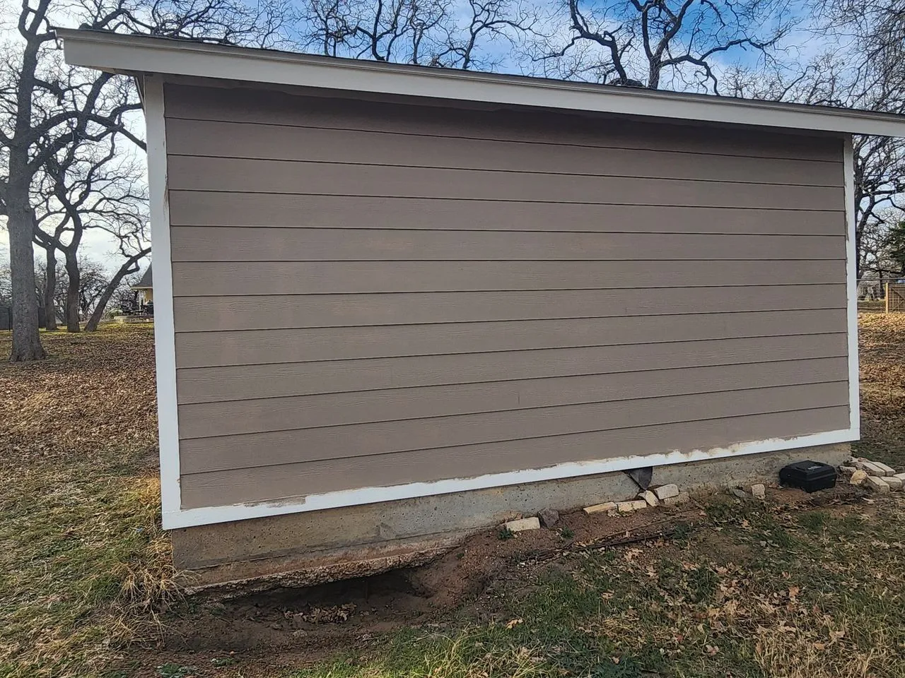 Ad Lib Family Construction siding: 08 outbuilding rear tan