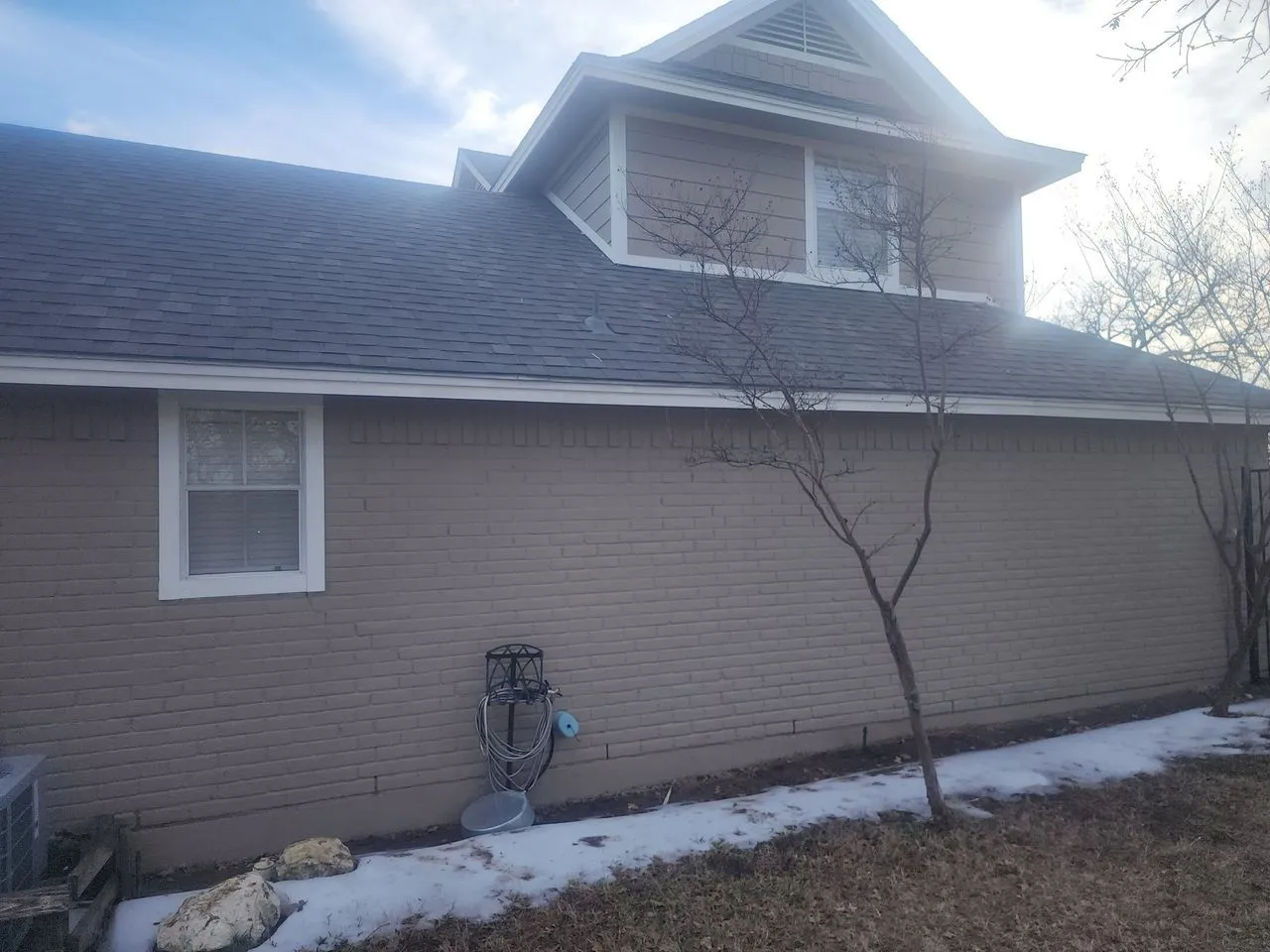 Ad Lib Family Construction roofing: 10 brick home dark shingle